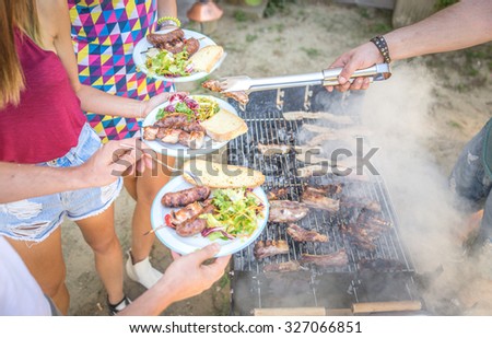 Barbecue in home garden, Host serving his guests - Group of friends making barbecue and having fun at private party