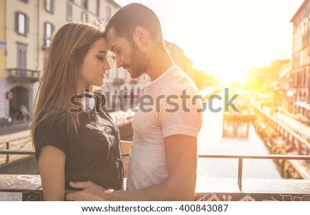 Image, Stock Photo Couple embracing on bridge under arch with flowers