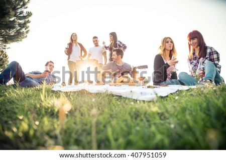 Group of friends having pic-nic in a park on a sunny day - People hanging out, having fun while grilling and relaxing Foto stock © 