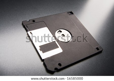 floppy disk lays on a gray background