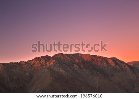 The sun is setting beautifully on the mountains in the Elqui Valley, Chile