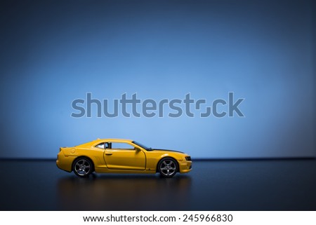 Chevrolet Camaro toy car product shot on blue background. Chevrolet is a automobile manufacturer at USA. Owner is General Motors Company. Shoot date and location: Turkey - Izmir. January 14 2015