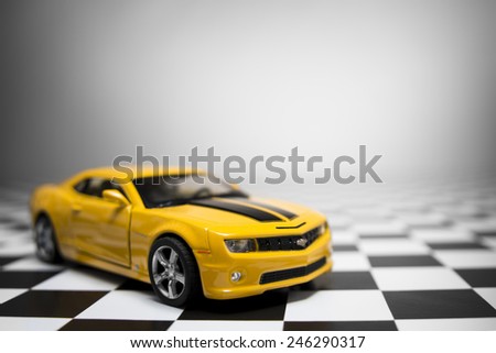 Chevrolet Camaro toy car product shot on checkered background. Chevrolet is a automobile manufacturer at USA. Owner is General Motors Company. Shoot date and location: Turkey - Izmir. January 14 2015