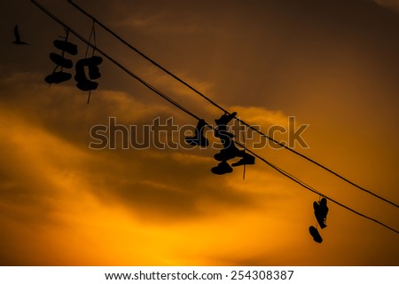 Shoe silhouettes on the electric conduit.