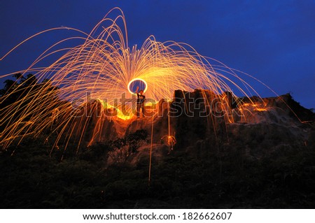 Burning steel wool fireworks during blue hour