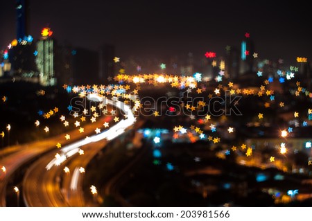 Blurred lights of Kuala Lumpur skyline, star shape bokeh