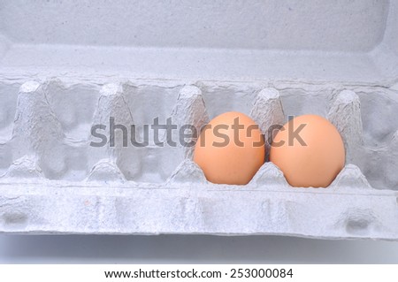 Eggs in paper tray isolated on white