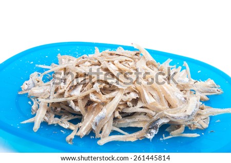 dried anchovies on plastic blue plate, malaysian food isolated on white background