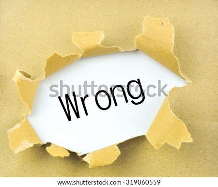 Business concept: torn paper with word wrong on Paper background