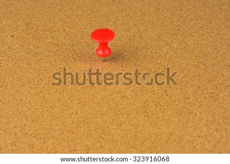 push pin pinned on corkboard