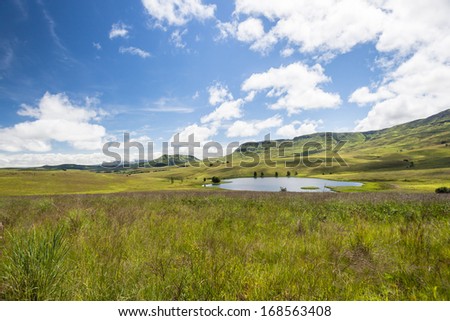 Summer Mountains Valley Lake Summer landscape at midday in mountain valley with distant dam waters