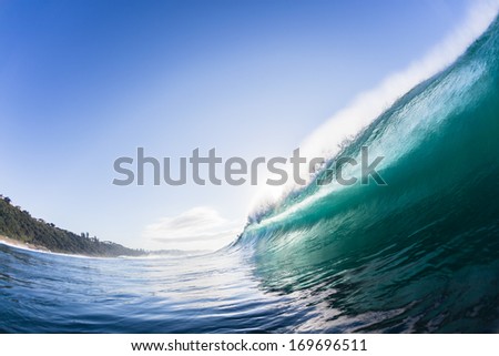 Ocean Wave Crashing  Swimming view of wave surging forward and crashing onto shallow reefs and sandbars with energy and power