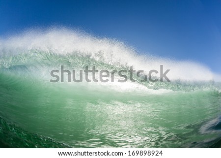 Ocean Wave Crashing Water Ocean wave curling crashing towards swimmers view in morning backlighting