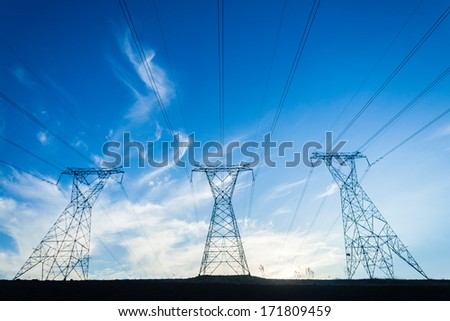 Electrical Power Lines Towers Electrical power line cables suspended from steel towers transporting energy supply to consumers in homes and economy.