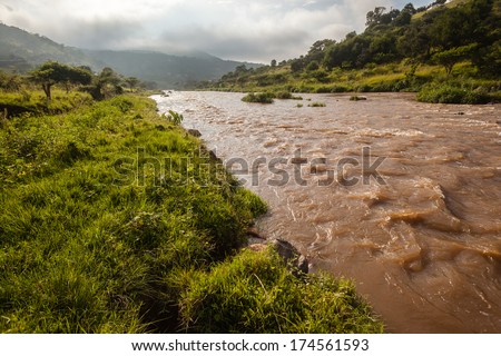 Flowing River Waters Valley Flowing river waters down summer green valley in early morning mist