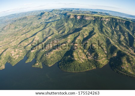 Air Flying Landscape Dam Rural Homes Air flying birds eye view of over Inanda dam valley terrain of thousand hills with homes over colorful landscape