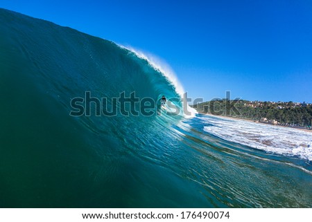 Surfing Hollow Wave Water Surfer tube rides inside hollow crashing blue ocean wave wall peeling perfectly. Water swimming angle view challenging nature .