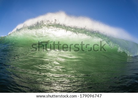 Wave Crashing Surfer Shadow Wave wall crashing towards sandbars with unidentified surfer shadow in the wall of water