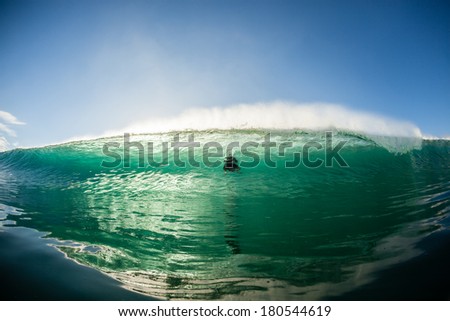Wave Crashing Surfer Shadow Hollow wave crashing with surfer shadow in wall of water