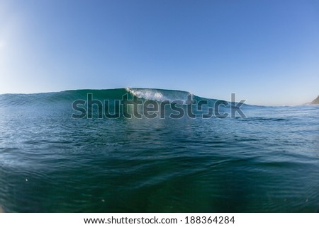 Ocean Wave Swell Blue  Ocean wave rolling crashing white water onto shallow reefs early morning