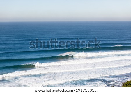 Ocean Waves Large Power  Large blue ocean waves upright vertical walls of water crashing with natures power and energy along beach coastline reefs