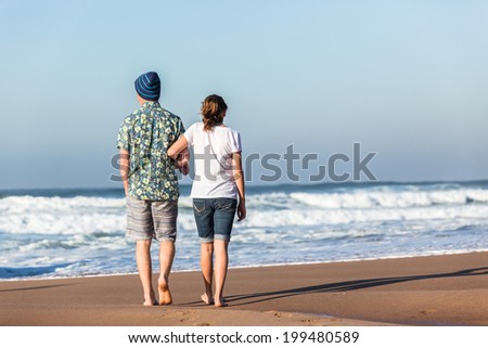 Teens Girl Boy Hanging Out  Beach Waves Teenagers boy girl morning hanging out social talk time walking together at beach with ocean waves.