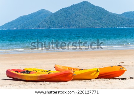 Kayaks Beach Ocean Kayak canoes on beach in tropical blue ocean waters landscape.