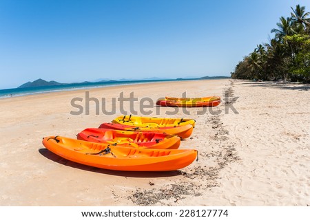 Kayaks Beach Ocean Kayak canoes on beach in tropical blue ocean waters landscape.