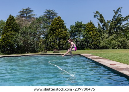 Girl Jumping Swim Pool Girl running jumping into swimming pool summer playtime.
