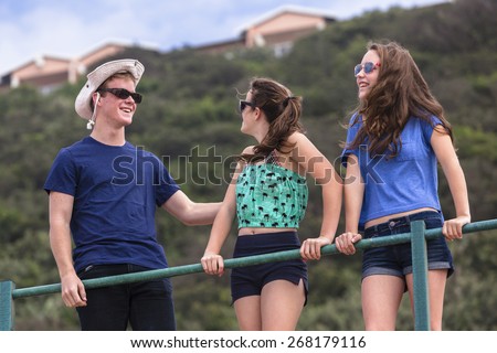 Boy Girls Beach Socializing\
Boy girl teenagers at beach holidays talk laughter socializing hangout.