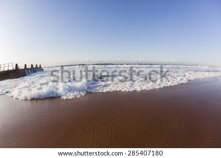 Wave White Water Beach\
Wave white water surge wash over beach sands alongside tidal pool  landscape