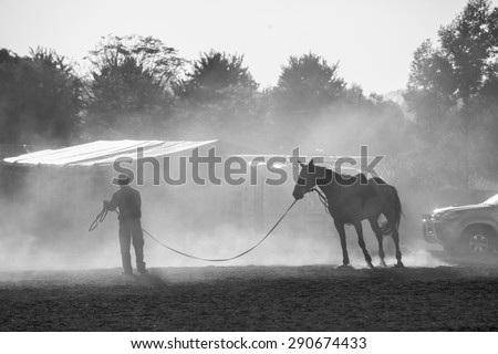 Horse Groom Dust \
Horse show jumping sand dust with Groom handler  in black and white tone contrasts at stables