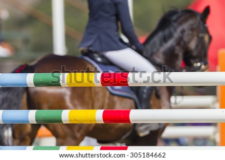Equestrian Horse Rider Poles\
Equestrian horse rider show jumping gates poles colors on arena course.