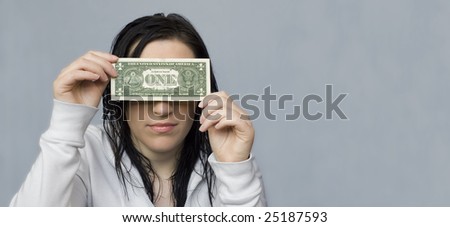 woman holing one dollar bill in front of her eyes