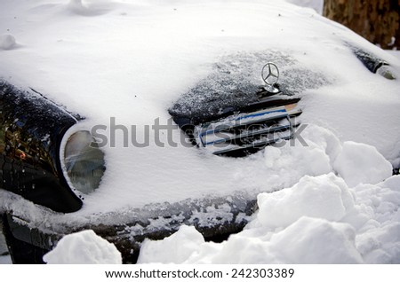 Odessa, Ukraine - 30 December, 2014: car under snow,  Natural disasters, blizzard, heavy snow paralyzed the city, collapse. Snow covered cars cyclone Europe