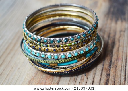 Beautiful expensive gold bracelets on wooden background