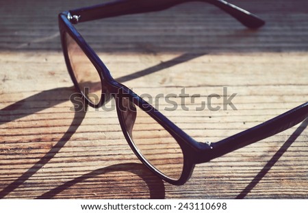 Black vintage reading glasses for computer on wooden table