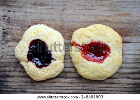 Homemade cookies with jam on wooden table
