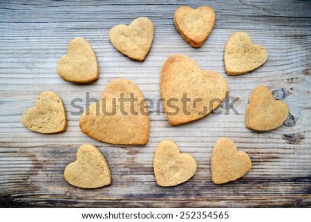 Gingerbread cookies in shape of heart on wooden table