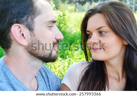 Man and woman in love looking at each other with passion and about to kiss