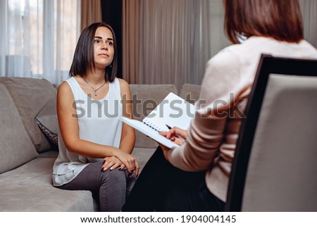 Beautiful worried woman at a psychologist appointment. Psychological problems. Mental problems concept Stockfoto © 