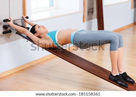 Woman stretching. Beautiful young woman in sports clothing doing stretching exercises