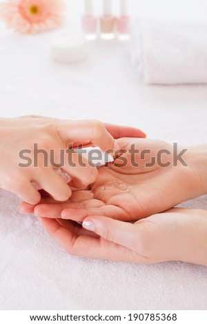 Spraying antiseptic. Close-up of manicure master spraying antiseptic on female finger