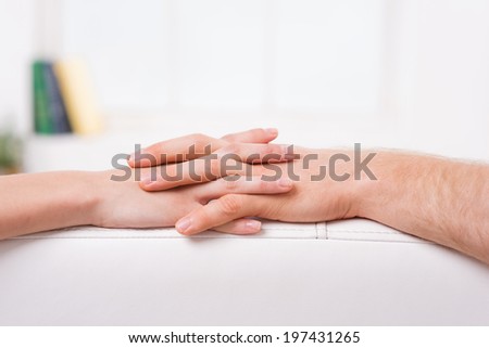 Never let you go. Close-up of man and woman holding hands