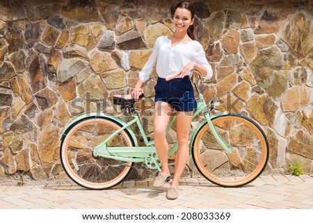 Woman with vintage bike. Full length of beautiful young smiling woman standing near her vintage bicycle