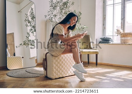 Similar – Image, Stock Photo young woman with luggage arrives at the train station by cab