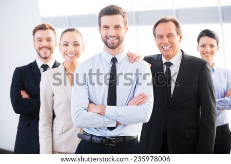 Successful business team. Group of confident business people in formal wear standing close to each other and smiling
