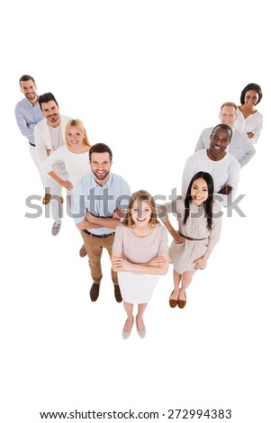 Leading her team to success. Top view of positive diverse group of people in smart casual wear looking at camera and smiling while standing close to each other