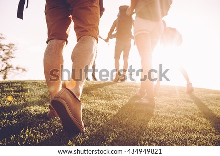 Similar – Image, Stock Photo Unrecognizable traveler walking up hill along road