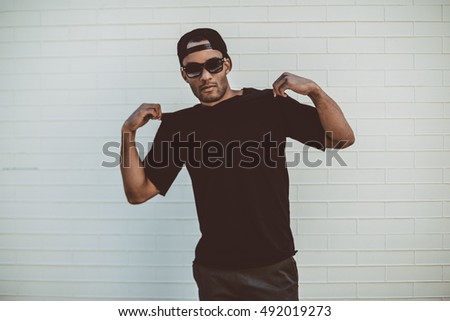 Similar – Image, Stock Photo Trendy ethnic model touching hair in projector light